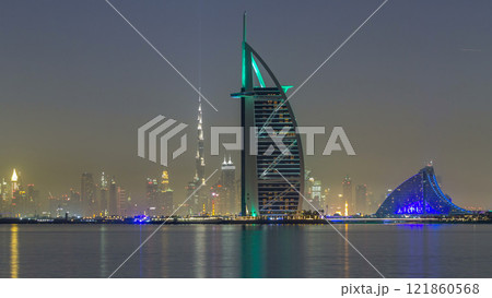 Skyline of Dubai by night with Burj Al Arab from the Palm Jumeirah timelapse hyperlapse. 121860568