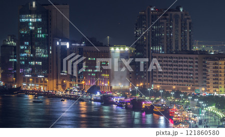 Dubai creek landscape night timelapse with boats and ship near waterfront Dubai creek landscape night timelapse with boats and ship near waterfront 121860580