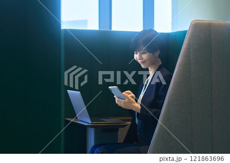 オフィスのブースでテレワークするスーツのビジネスウーマン撮影協力:LINK FOREST オフィスのブースでテレワークするスーツのビジネスウーマン撮影協力:LINK FOREST 121863696
