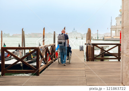 Wooden Dock with Gondolas in Venice, Italy Wooden Dock with Gondolas in Venice, Italy 121863722