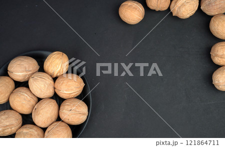 Walnut and Black background Walnut and Black background 121864711