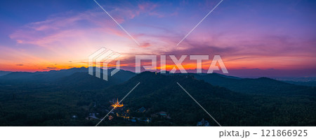 Aerial view of Majestic Buddha on the mountain at colorful sunset. Aerial view of Majestic Buddha on the mountain at colorful sunset. 121866925