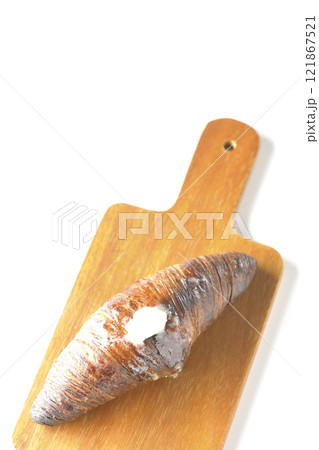 カッティングボードに乗ったちょっと焦げてる黒ワッサンを白背景で撮影 カッティングボードに乗ったちょっと焦げてる黒ワッサンを白背景で撮影 121867521