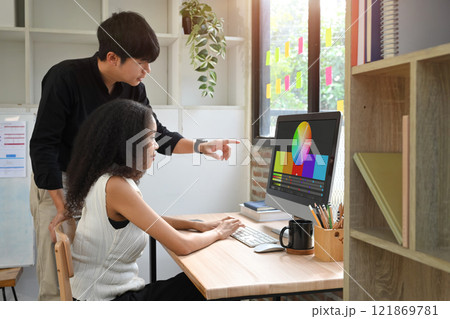 Team of designer working together on color palette displayed on computer screen in modern office Team of designer working together on color palette displayed on computer screen in modern office 121869781