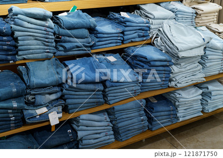 Denim display in a retail store highlighting various styles and colors 121871750