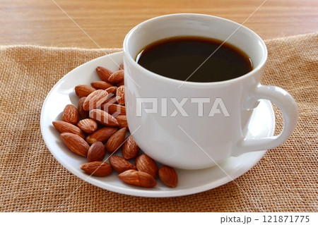テーブルに置かれたコーヒーとアーモンド テーブルに置かれたコーヒーとアーモンド 121871775