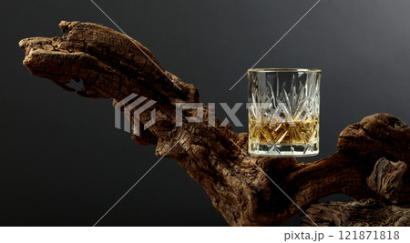 Glass of whiskey on a old snag. 121871818