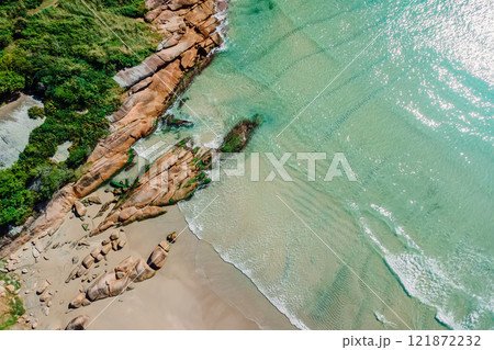 Beach with rocks and transparent clear ocean in Brazil. Aerial view of Barra da Lagoa in Florianopolis Beach with rocks and transparent clear ocean in Brazil. Aerial view of Barra da Lagoa in Florianopolis 121872232