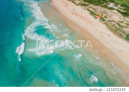 Sandy beach and blue ocean with waves in Brazil, Florianopolis. Aerial view of Campeche beach 121872245