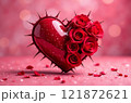 A red textured heart, one side of which consists of red rosebuds, the other side of the heart is covered with thorns in the center close-up on a pink background with red stones at the bottom. The 121872621