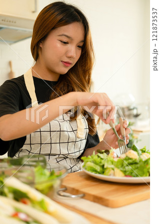 A female homecook enjoying her salad A female homecook enjoying her salad 121873537