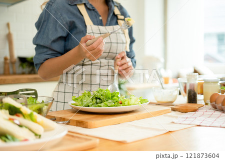A home-cook eating her own salad A home-cook eating her own salad 121873604