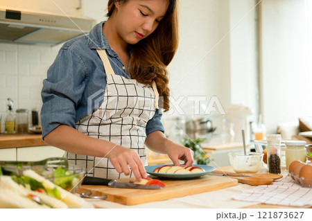 A woman plating her healthy fruit 121873627