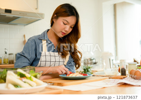 A young woman eating an apple 121873637
