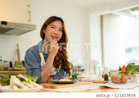 A young woman eating an apple A young woman eating an apple 121873639