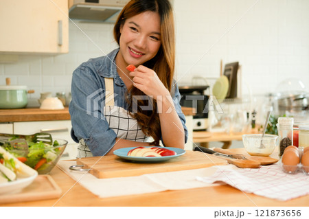 A young woman eating an apple 121873656