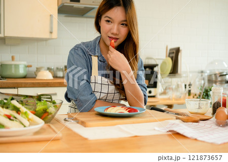 A young woman eating an apple 121873657