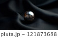 Single black pearl on elegant dark fabric, 121873688