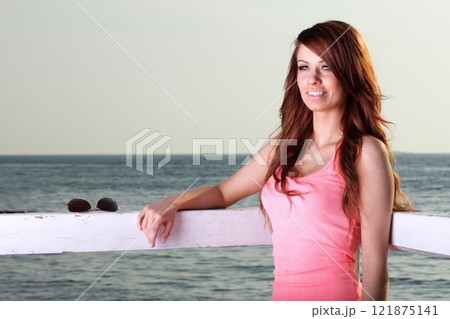 Attractive girl on pier Young woman and sea 121875141