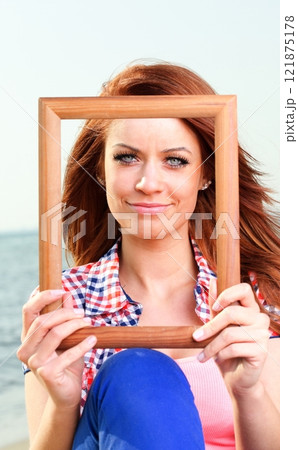 Woman Holding Frame travel concept Woman Holding Frame travel concept 121875178