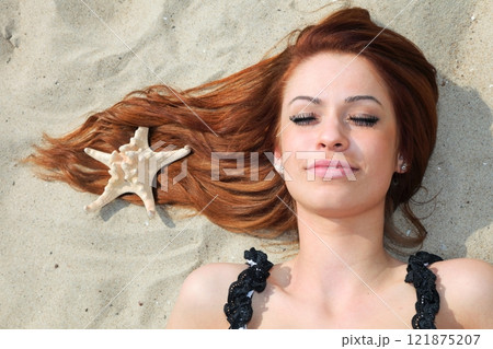 The beautiful girl lies on sea coast with shells nature vacation The beautiful girl lies on sea coast with shells nature vacation 121875207
