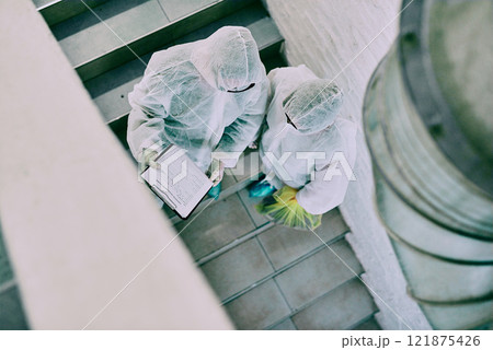 Medical team and covid hygiene healthcare professionals wearing hazmat suits for safety while working at quarantine site. Above first responders in protective gear to fight virus with innovation Medical team and covid hygiene healthcare professionals wearing hazmat suits for safety while working at quarantine site. Above first responders in protective gear to fight virus with innovation 121875426