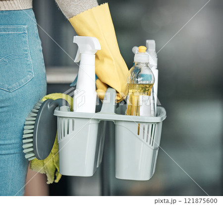 Domestic worker, maid or cleaner hands holding or carrying cleaning products and equipment or supplies. For home hygiene, contact us for a handy helper agency or professional household service. 121875600