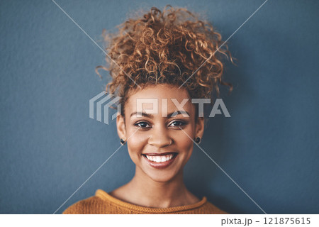 Face of a happy, confident and beautiful black woman with a positive mindset a bright smile. Portrait of a carefree, pretty and attractive African American female, isolated on a studio background 121875615