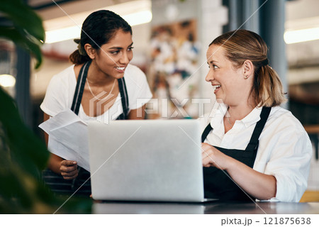 Small business owner working on a budget strategy or ordering stock online with an employee using a laptop in her store. Female entrepreneur talking to a worker about startup growth and sales Small business owner working on a budget strategy or ordering stock online with an employee using a laptop in her store. Female entrepreneur talking to a worker about startup growth and sales 121875638