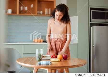 Healthy, wellness lifestyle and diet meal plan preparations or woman making breakfast fruit salad or smoothie on home kitchen table. Female preparing organic vegan food, cutting fresh ingredients. Healthy, wellness lifestyle and diet meal plan preparations or woman making breakfast fruit salad or smoothie on home kitchen table. Female preparing organic vegan food, cutting fresh ingredients. 121875651