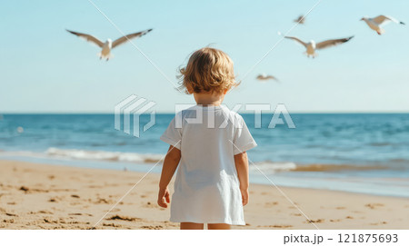 child chasing seagulls along shore, enjoying sunny beach day. ocean waves gently lap at sand, creating joyful atmosphere 121875693
