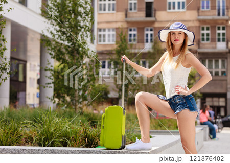 Attractive woman tourist with suitcase ready to travel Attractive woman tourist with suitcase ready to travel 121876402