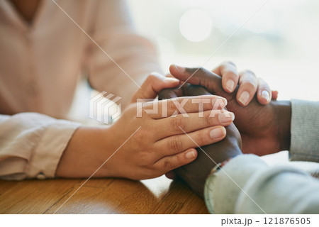 Comfort, kindness and forgiveness with a biracial couple holding hands, united in support in a crisis. Caring wife showing love to her depressed husband with a gentle gesture of affection 121876505