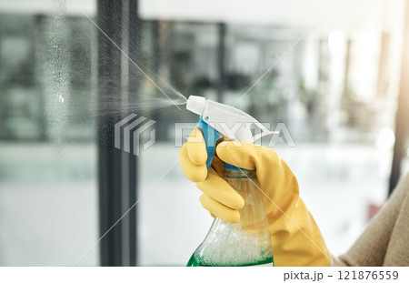 Clean, wash and day chores at home with a household hygiene spray bottle for windows inside. Closeup of cleaning job, washing and working hand with gloves spraying glass cleaner with care indoors Clean, wash and day chores at home with a household hygiene spray bottle for windows inside. Closeup of cleaning job, washing and working hand with gloves spraying glass cleaner with care indoors 121876559