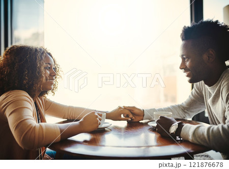 In love, caring and dating young couple bonding together on a romantic date in a coffee shop or cafe. Affectionate man and woman relaxing, spending time and smiling while sitting in a restaurant In love, caring and dating young couple bonding together on a romantic date in a coffee shop or cafe. Affectionate man and woman relaxing, spending time and smiling while sitting in a restaurant 121876678