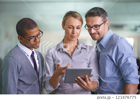 Working, thinking and planning on a tablet of a business team developing a project. Tech marketing group work on a web research collaboration. Office workers looking at a digital device together 121876775