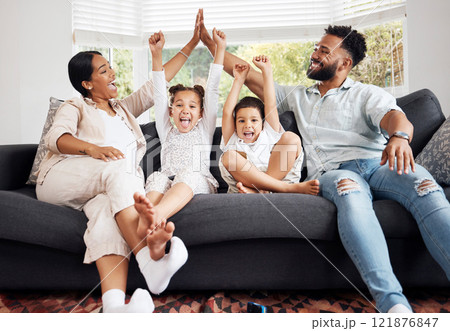 Happy parents and excited children celebrate on the sofa while watching tv. Fun family time, relaxing at home and bonding. Mother and father high five, kids cheer for sports team win. Happy parents and excited children celebrate on the sofa while watching tv. Fun family time, relaxing at home and bonding. Mother and father high five, kids cheer for sports team win. 121876847