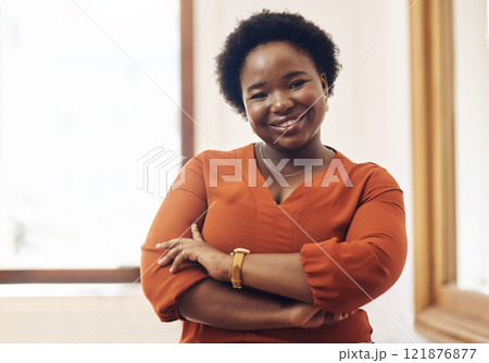 Portrait of smiling, friendly casual african american business woman leader, standing confident with arms crossed in modern office. Cheerful professional female designer working in startup company 121876877