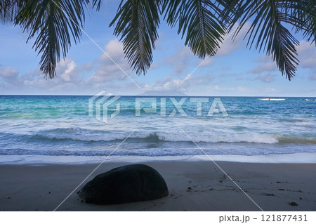 Landscape with the Indian Ocean and palm trees. Mahe Island, Seychelles Landscape with the Indian Ocean and palm trees. Mahe Island, Seychelles 121877431