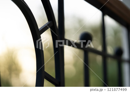 Curved forged modern fence on the balcony closeup. 121877499