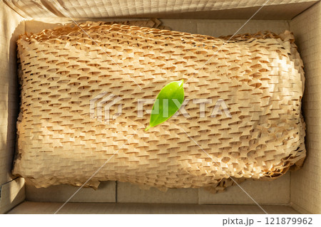 Green leaf on eco friendly brown paper honeycomb wrap for product packaging parcel carton box Green leaf on eco friendly brown paper honeycomb wrap for product packaging parcel carton box 121879962