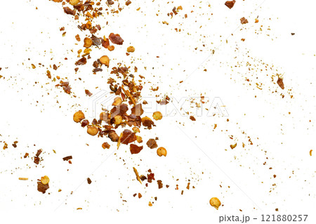 dried red chili pepper flakes and seeds isolated on white background 121880257