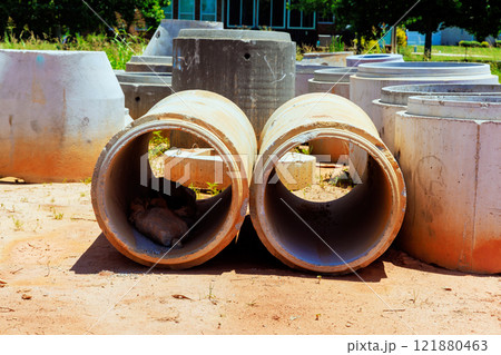 Concrete pipes are scattered in construction area with ready for installation. 121880463