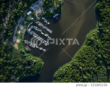 Bird's-eye view of luxury yachts and speedboats in the marina and yacht club. Bird's-eye view of moored sailboats. Bird's-eye view of luxury yachts and speedboats in the marina and yacht club. Bird's-eye view of moored sailboats. 121881210
