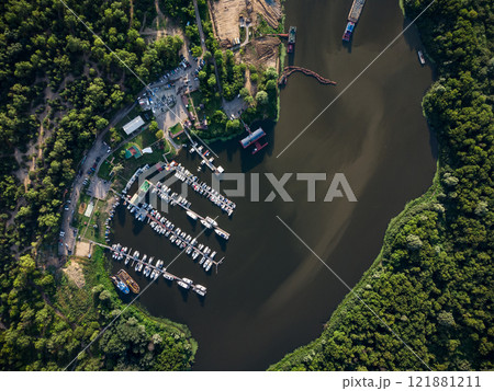 Bird's-eye view of luxury yachts and speedboats in the marina and yacht club. Bird's-eye view of moored sailboats. 121881211