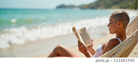 Relaxing on the beach while reading a book under the warm sun with soft waves gently lapping at the shore 121881595