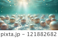 Lustrous pearls underwater with sunlit glow 121882682