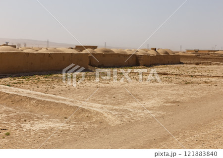 Mud brick structures in Jowzjan Province, Afghanistan under a clear sky 121883840