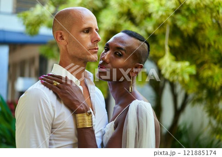 LGBTQ couple in tropical villa wedding. Gender fluid black bride in white dress, groom in stylish suit. Love, diversity. Unique bridal fashion and bold jewelry embrace inclusivity. 121885174