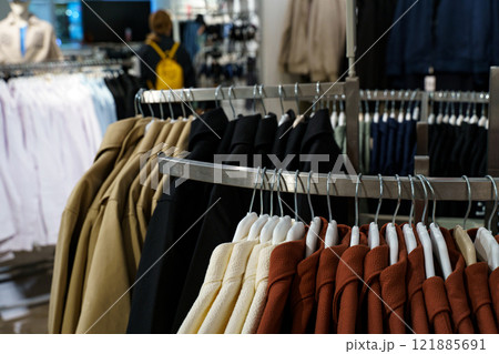 Stylish clothing display in a vibrant retail store during shopping hours Stylish clothing display in a vibrant retail store during shopping hours 121885691